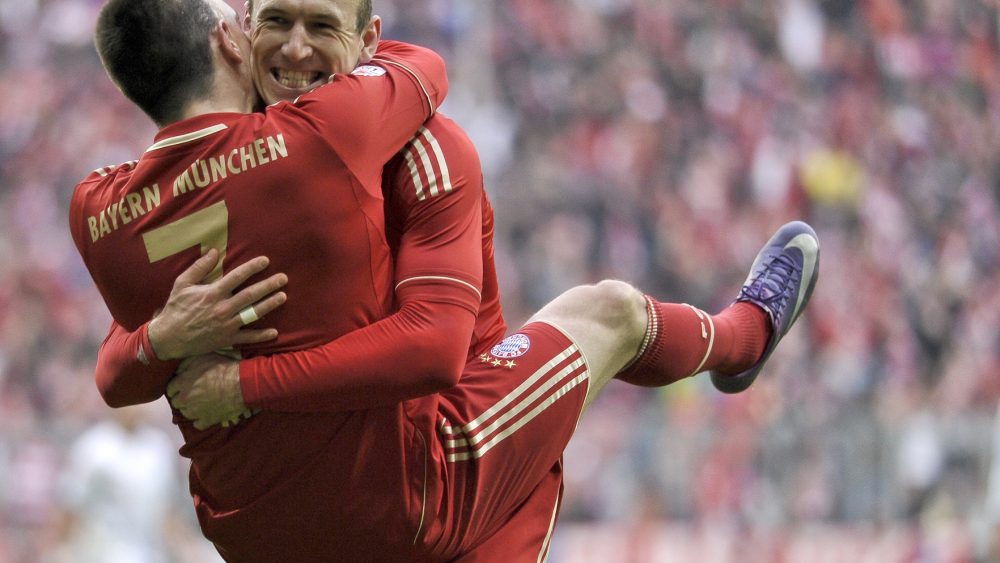 Bayern Munich's French midfielder Franck Ribery (L) is greeted by midfielder Arjen Robben (R) after scoring the seventh goal for his team during the German first division Bundesliga football match FC Bayern Munich vs TSG 1899 Hoffenheim in Munich southern Germany on March10, 2012. AFP PHOTO / GUENTER SCHIFFMANN
