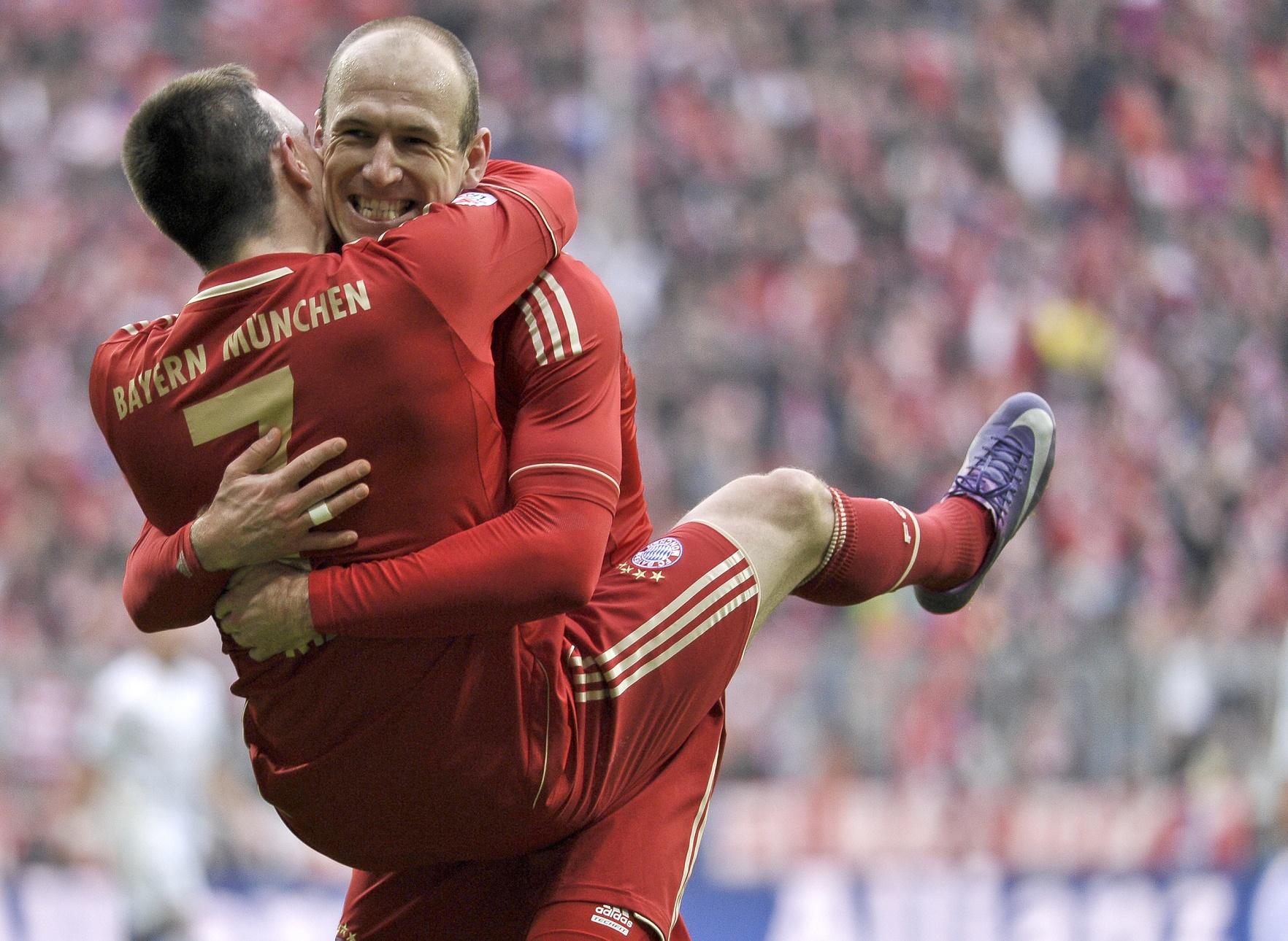 Bayern Munich's French midfielder Franck Ribery (L) is greeted by midfielder Arjen Robben (R) after scoring the seventh goal for his team during the German first division Bundesliga football match FC Bayern Munich vs TSG 1899 Hoffenheim in Munich southern Germany on March10, 2012. AFP PHOTO / GUENTER SCHIFFMANN