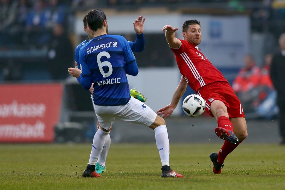 Xabi Alonso fighting for the ball. (Photo: Christof Koepsel / Bongarts / Getty Images)