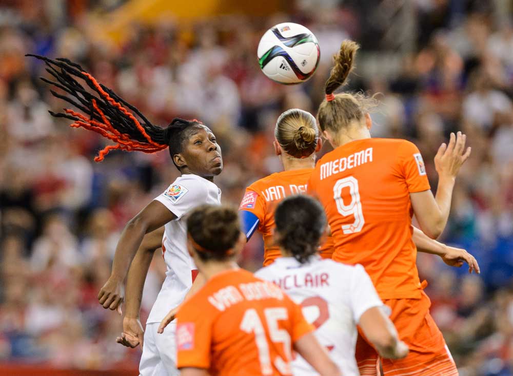 MONTREAL, QC - JUNE 15: Kadeisha Buchanan #3 of Canada and Vivianne Miedema #9 of the Netherlands jump for the ball during the 2015 FIFA Women's World Cup Group A match at Olympic Stadium on June 15, 2015 in Montreal, Quebec, Canada. Final score between Canada and the Netherlands 1-1. (Photo by Minas Panagiotakis/Getty Images)