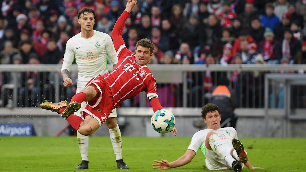 MUNICH, GERMANY - JANUARY 21: Thomas Mueller of FC Bayern Muenchen scores his team's first goal during the Bundesliga match between FC Bayern Muenchen and SV Werder Bremen at Allianz Arena on January 21, 2018 in Munich, Germany. (Photo by Matthias Hangst/Bongarts/Getty Images)