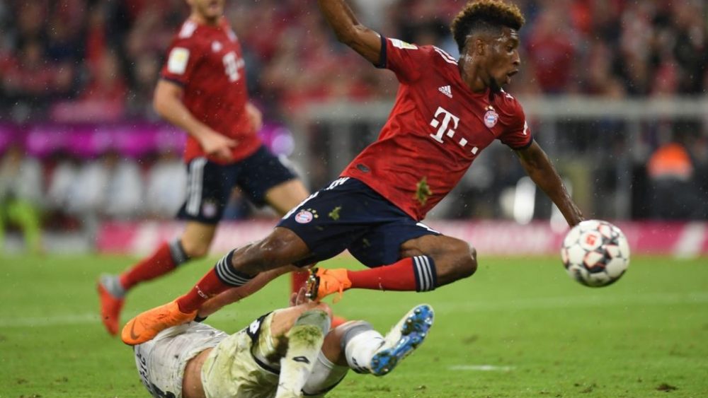 Bayern Munich's French forward Kingsley Coman (R) is fouled by Hoffenheim's Bosnian defender Ermin Bicakcic during the German first division Bundesliga football match FC Bayern Munich v TSG 1899 Hoffenheim at the Allianz Arena in Munich, southern Germany on August 24, 2018. (Photo by Christof STACHE / AFP)