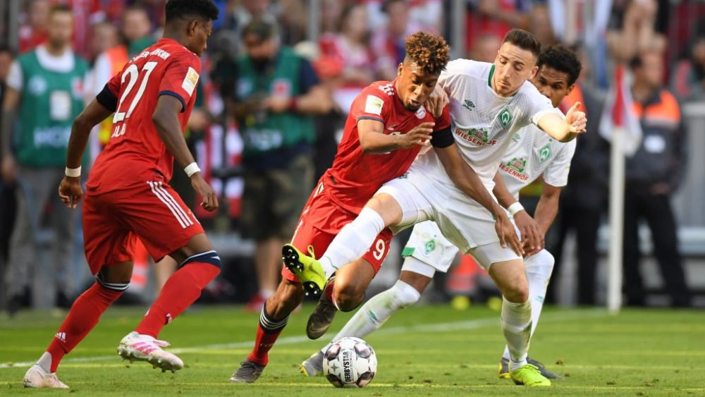 MUNICH, GERMANY - APRIL 20: Kingsley Coman of Bayern Munich battles for possession with Kevin Mohwald of Werder Bremen during the Bundesliga match between FC Bayern Muenchen and SV Werder Bremen at Allianz Arena on April 20, 2019 in Munich, Germany. (Photo by Matthias Hangst/Bongarts/Getty Images)