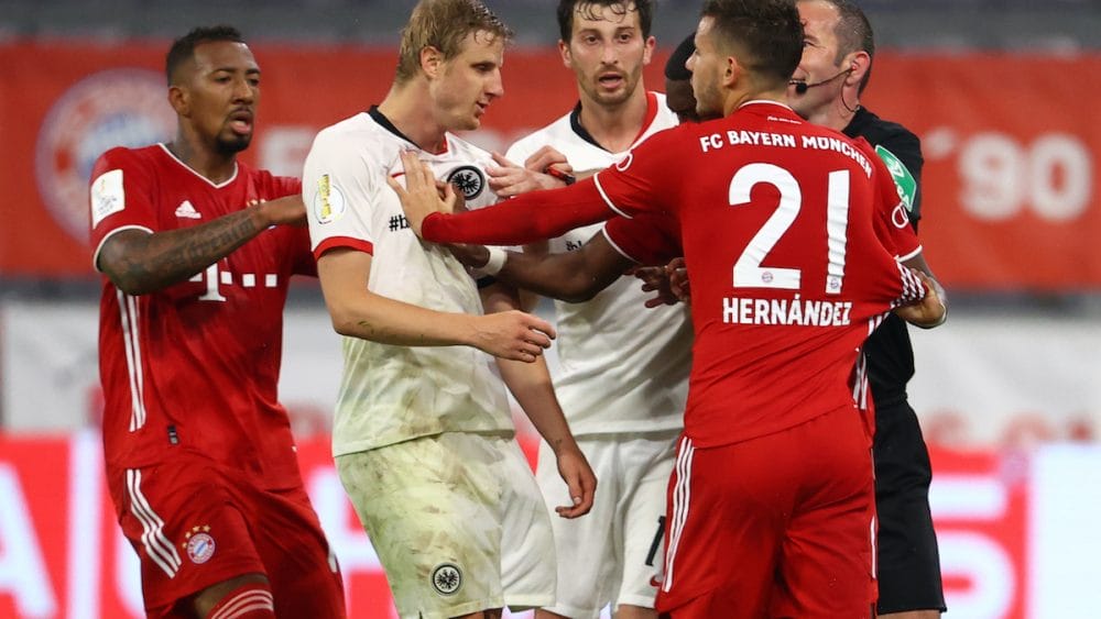 MUNICH, GERMANY - JUNE 10: Players from both sides clash during the DFB Cup semifinal match between FC Bayern Muenchen and Eintracht Frankfurt at Allianz Arena on June 10, 2020 in Munich, Germany. (Photo by Kai Pfaffenbach/Pool via Getty Images)