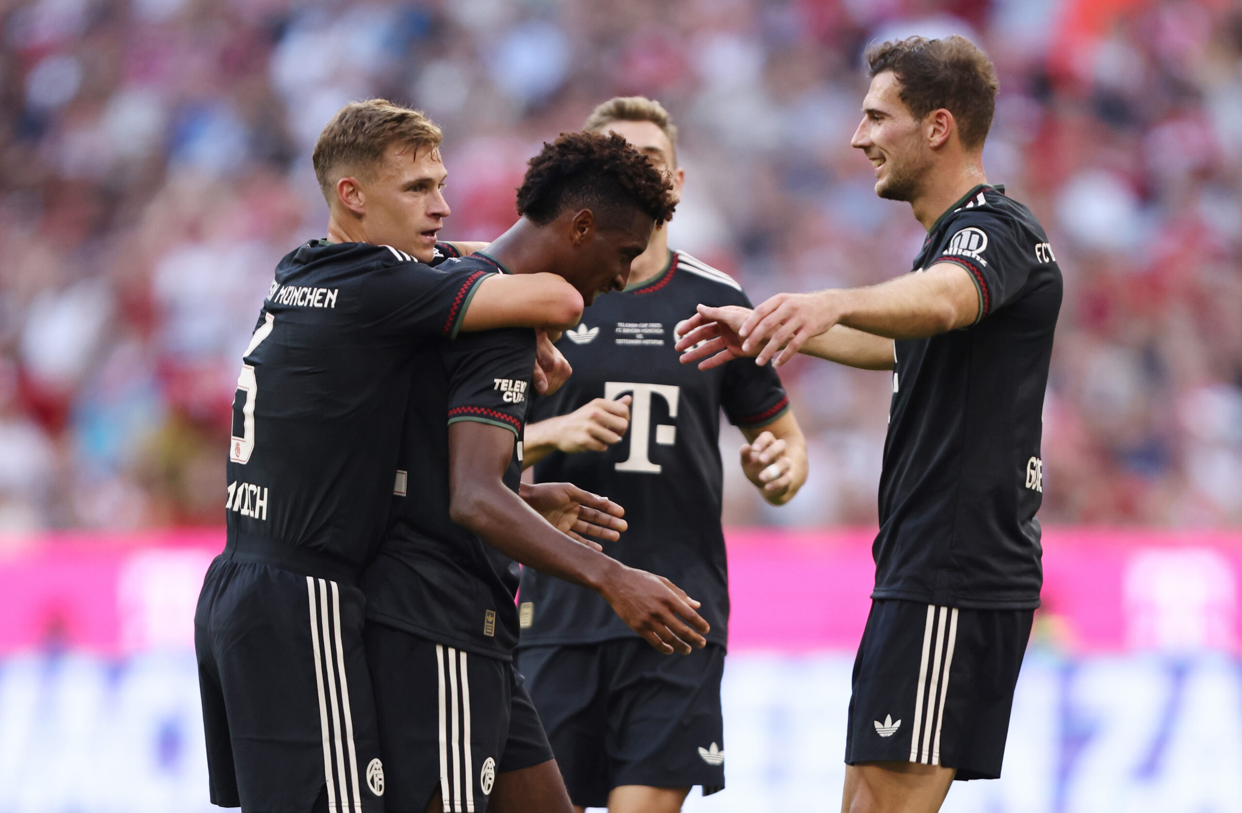 Kingsley Coman wird von seinen Teamkollegen beim FC Bayern umarmt und gefeiert.