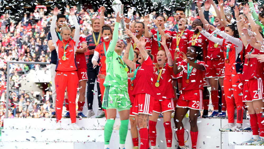 Die FC Bayern Frauen heben den DFB-Pokal nach dem Sieg gegen den VfL Wolfsburg in die Luft.